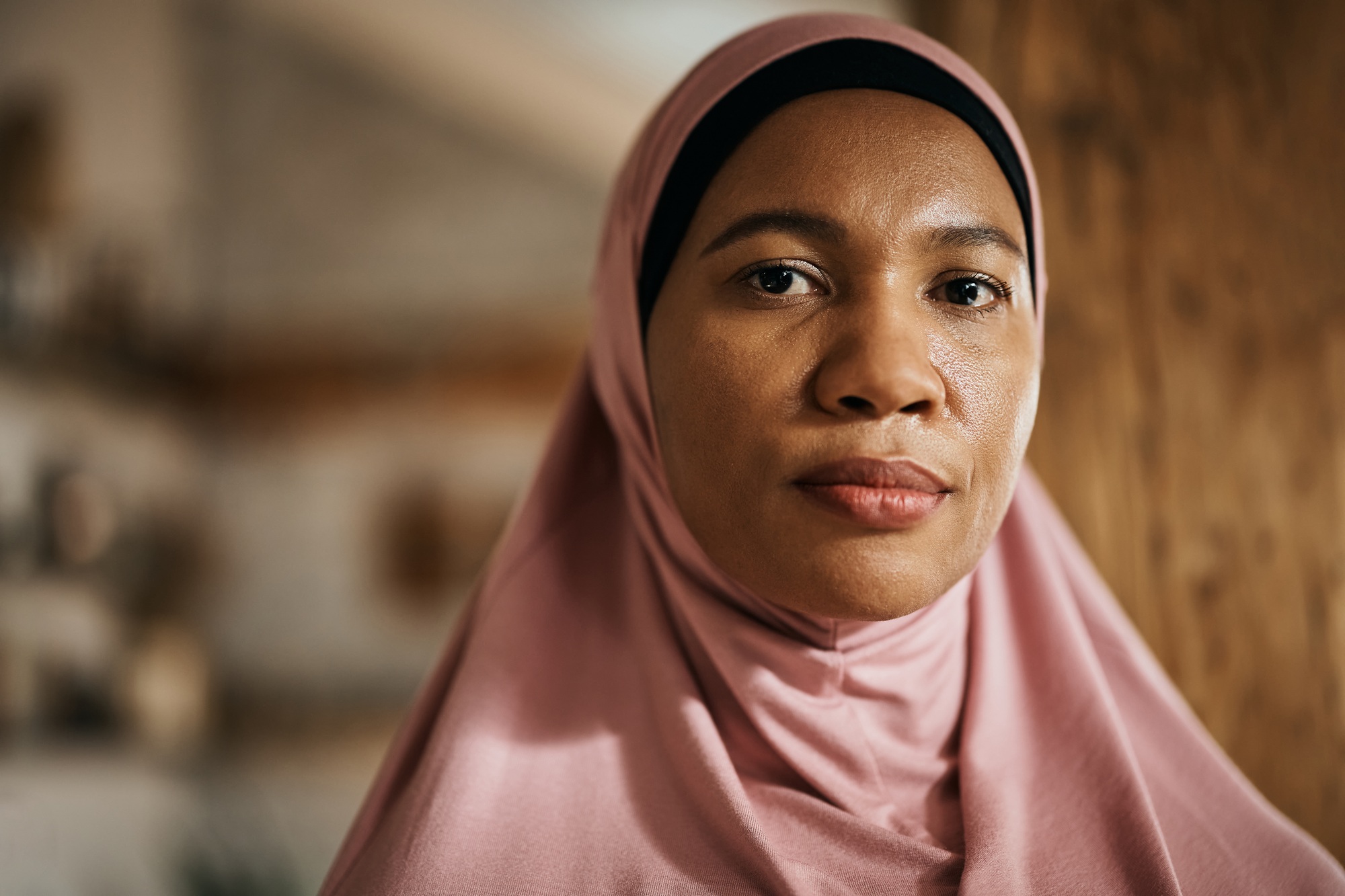 African American Muslim woman in hijab looking at camera.
